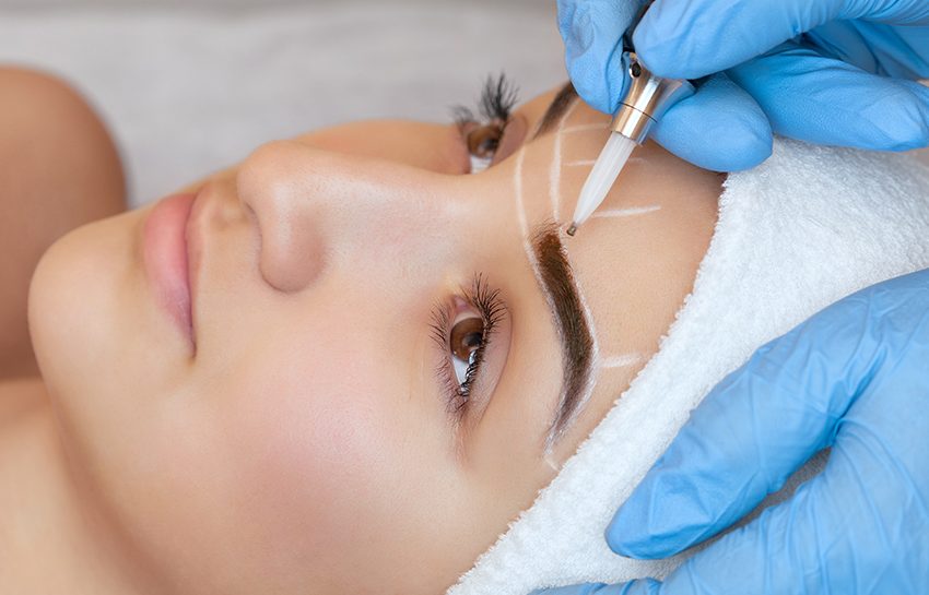 A girl getting mircrobladed eyebrows